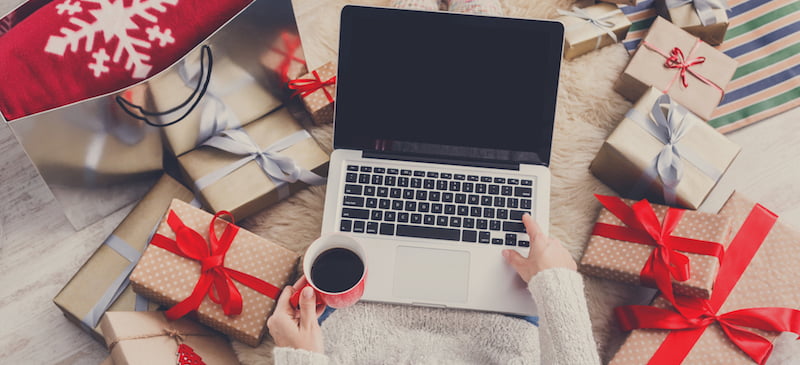 Woman Holiday Shopping Surrounded by Presents Feature