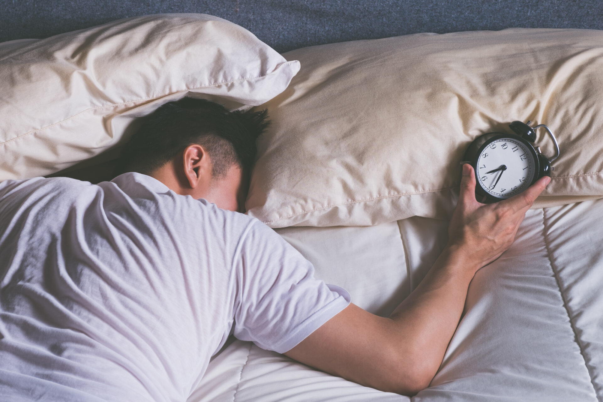 Man sleeping with alarm clock